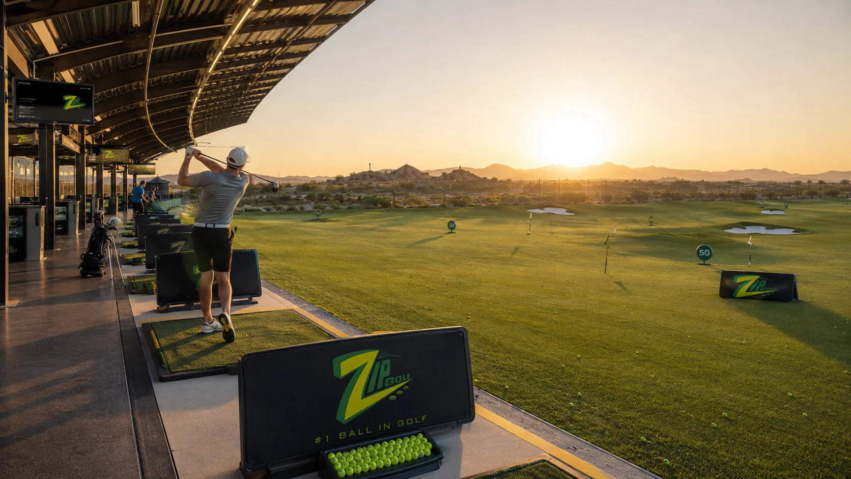ZIPGOLF driving range at sunrise with golfers hitting balls